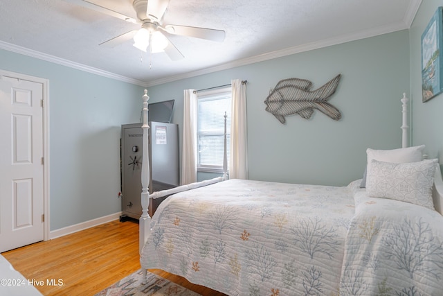 bedroom with hardwood / wood-style flooring, ceiling fan, and ornamental molding