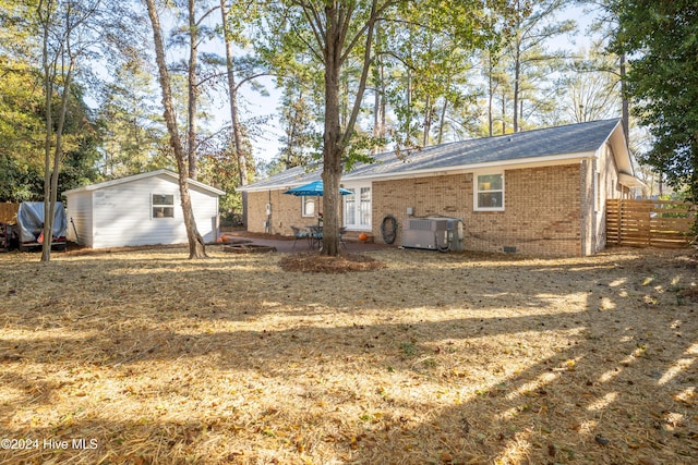 exterior space with a storage shed and central air condition unit