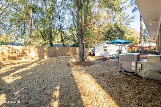 view of yard featuring cooling unit and a patio area