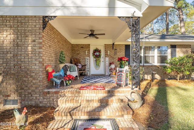 doorway to property featuring a porch and ceiling fan