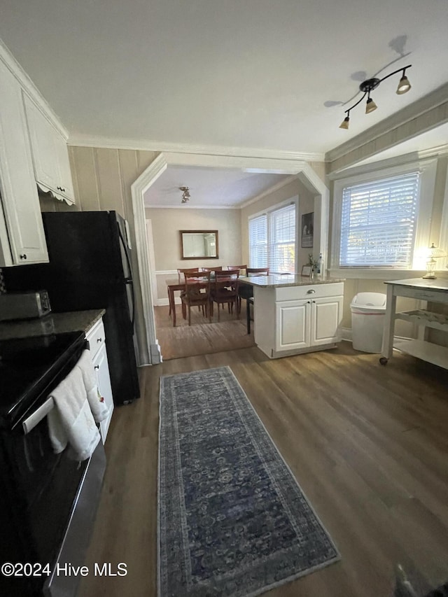 kitchen featuring kitchen peninsula, white cabinets, dark hardwood / wood-style flooring, and black electric range oven