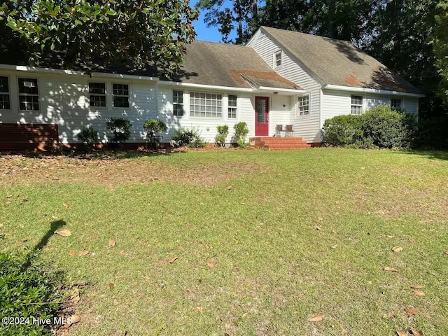 new england style home featuring a front lawn