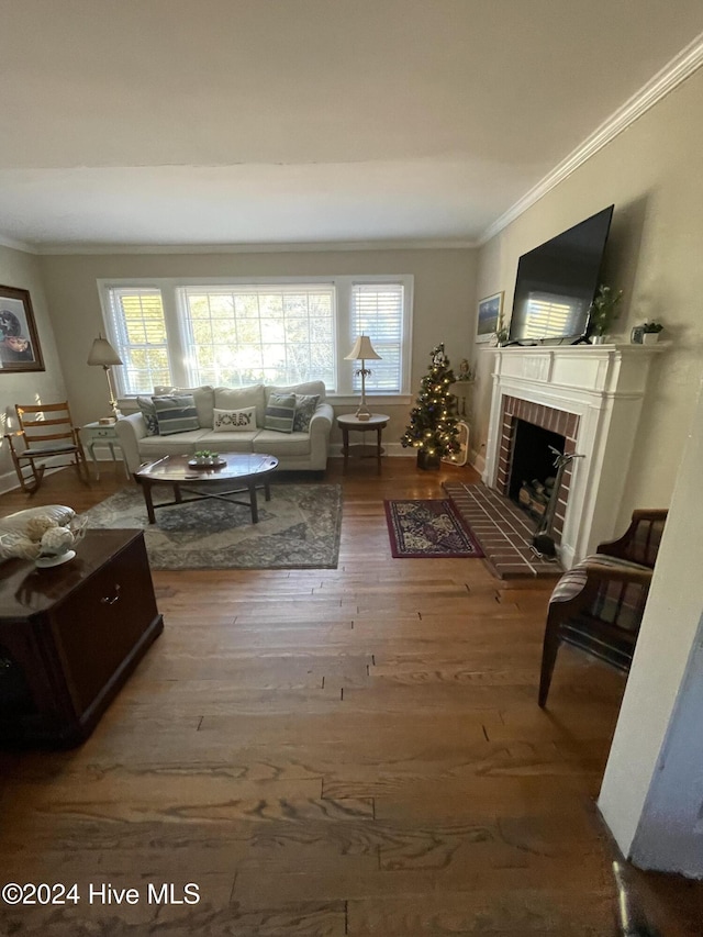 living room featuring a brick fireplace, ornamental molding, a healthy amount of sunlight, and hardwood / wood-style flooring