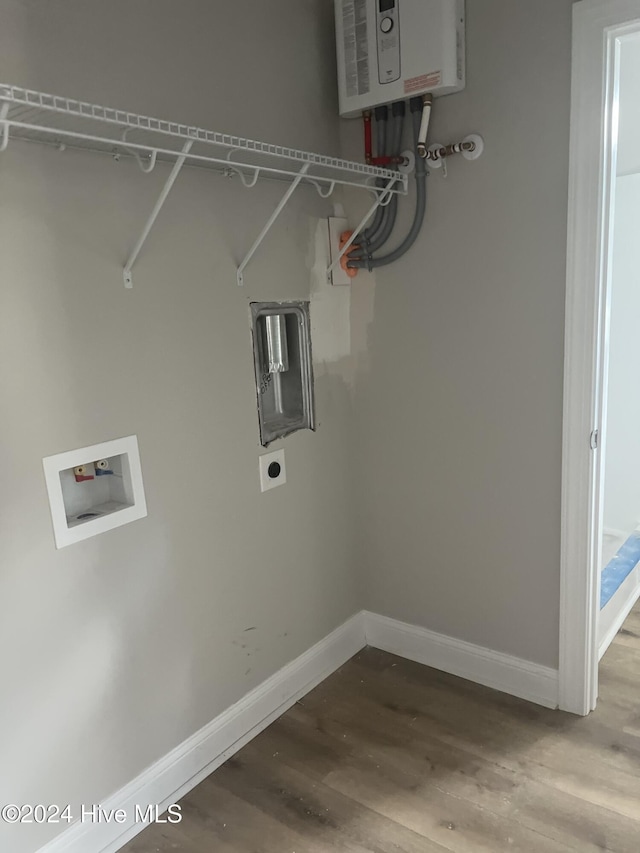 laundry room featuring hardwood / wood-style flooring, hookup for an electric dryer, hookup for a washing machine, and water heater