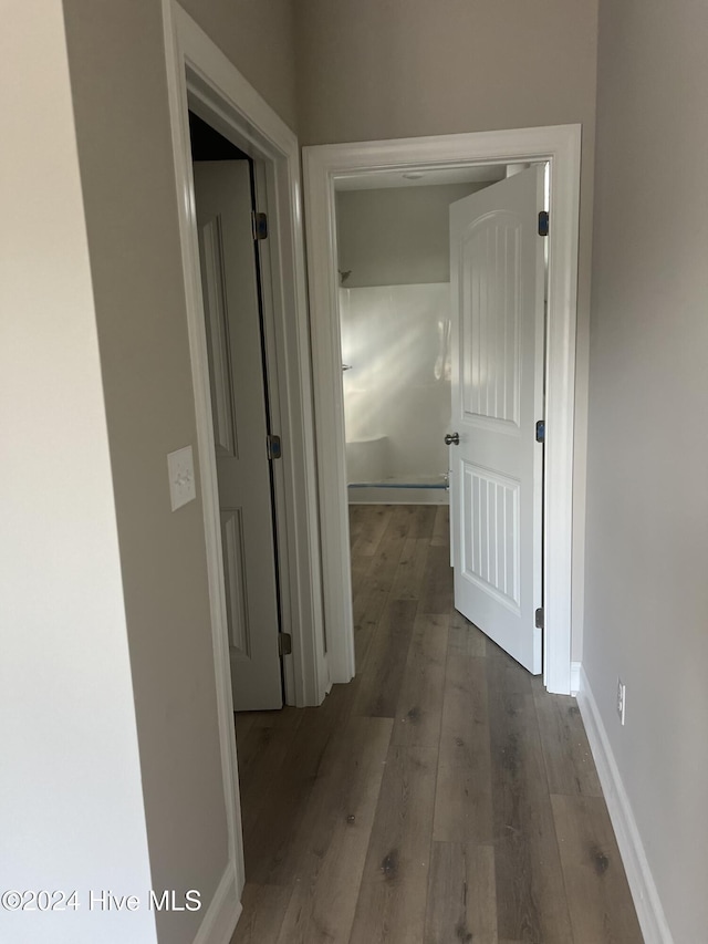 hallway featuring wood-type flooring