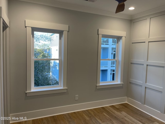 empty room with hardwood / wood-style flooring and ceiling fan