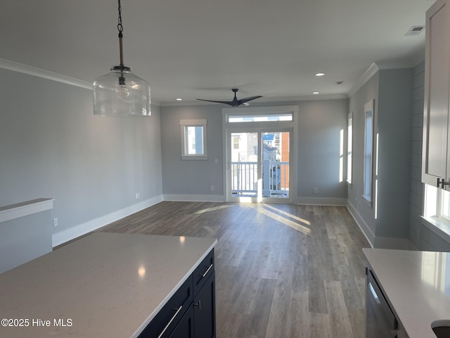 interior space with crown molding, ceiling fan, and hardwood / wood-style flooring