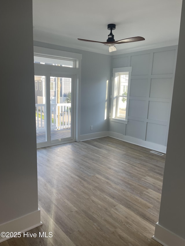 empty room with hardwood / wood-style flooring and ceiling fan