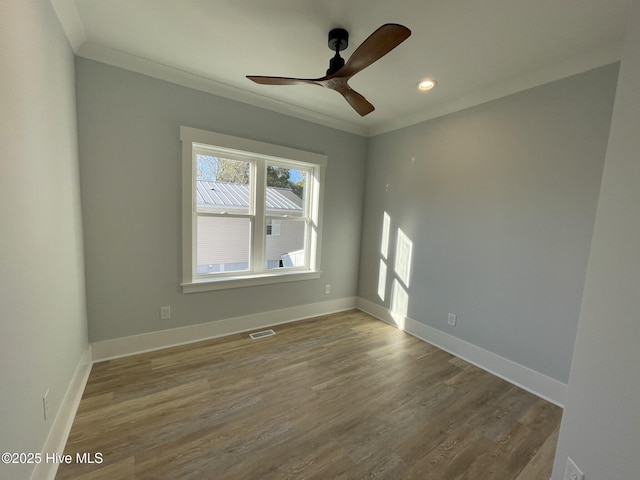 unfurnished room with ornamental molding, wood-type flooring, and ceiling fan