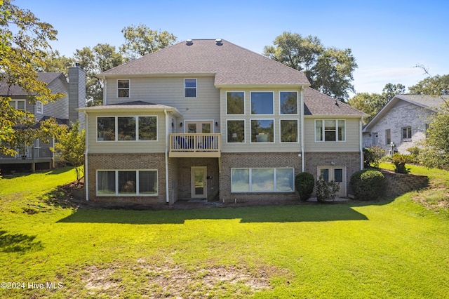 back of property featuring a lawn