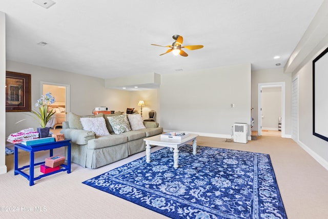 living room featuring carpet flooring and ceiling fan