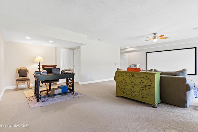 interior space with ceiling fan, carpet floors, and a textured ceiling