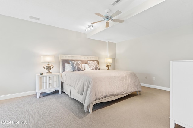 carpeted bedroom featuring ceiling fan and rail lighting