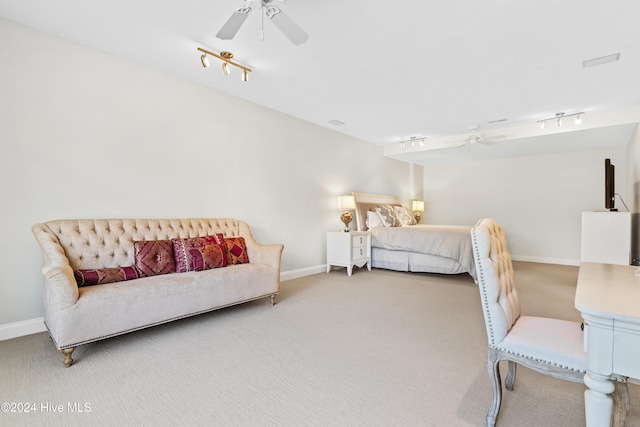 carpeted bedroom featuring ceiling fan and rail lighting