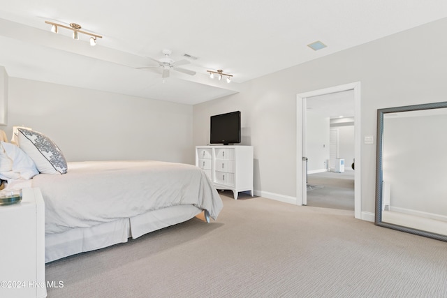 bedroom featuring carpet, ceiling fan, and rail lighting