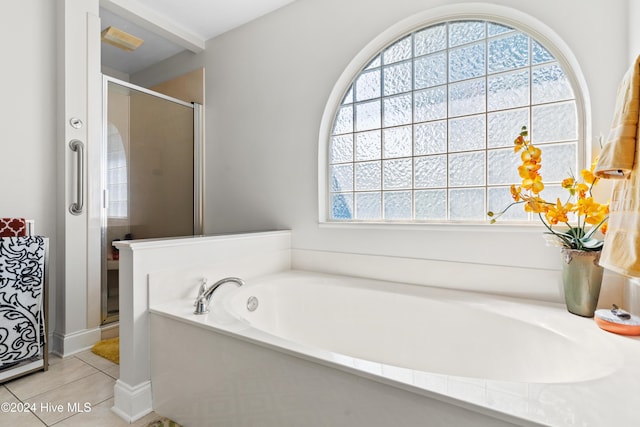 bathroom featuring tile patterned floors and separate shower and tub