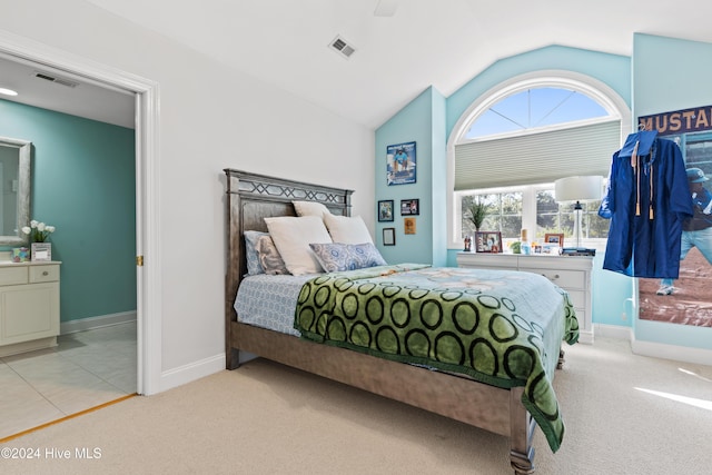 bedroom with ceiling fan, lofted ceiling, and light carpet