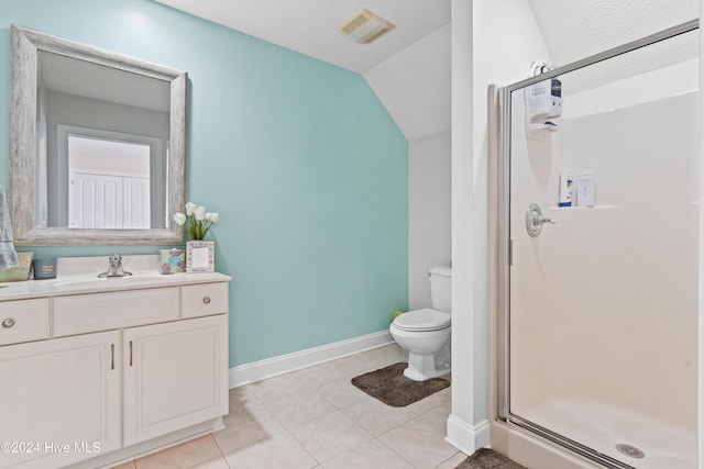 bathroom featuring vanity, lofted ceiling, tile patterned floors, toilet, and walk in shower