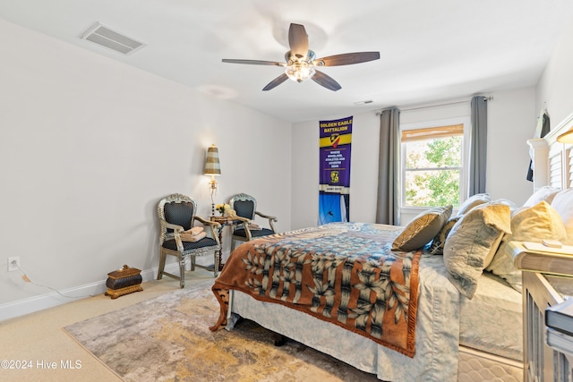 bedroom with light colored carpet and ceiling fan