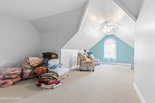 interior space with carpet flooring, vaulted ceiling, and ceiling fan