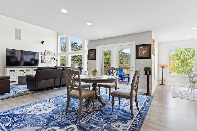 dining area with hardwood / wood-style floors and a healthy amount of sunlight