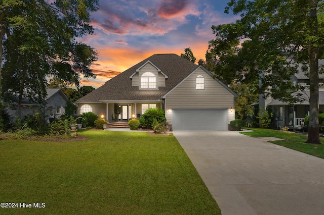 view of front facade with a garage and a yard