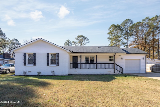 ranch-style house featuring covered porch, a garage, and a front yard