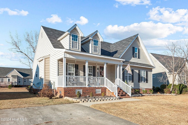 cape cod home with a front lawn and a porch