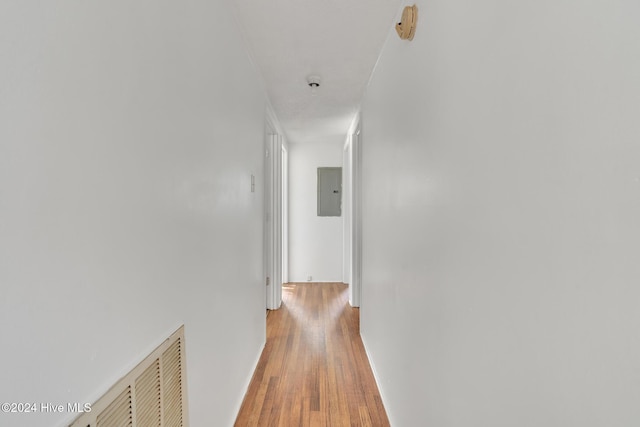 hall with electric panel and hardwood / wood-style floors