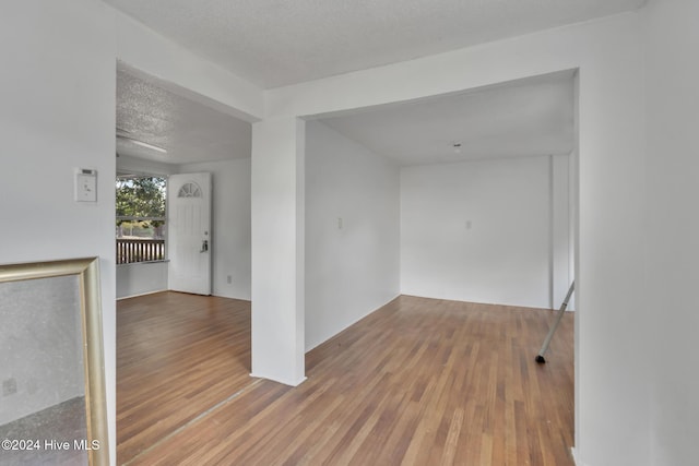 spare room with wood-type flooring and a textured ceiling