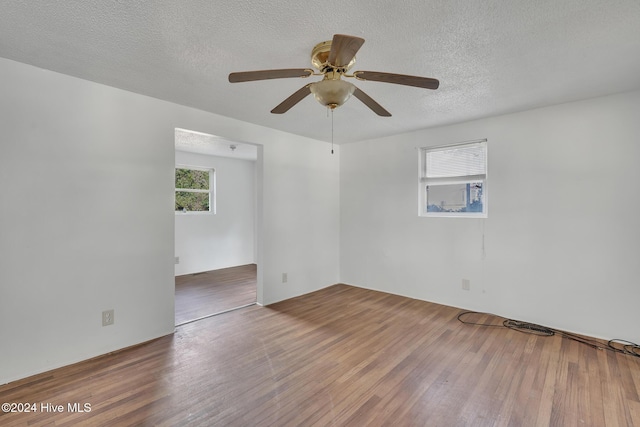 unfurnished room featuring ceiling fan, a textured ceiling, and hardwood / wood-style flooring