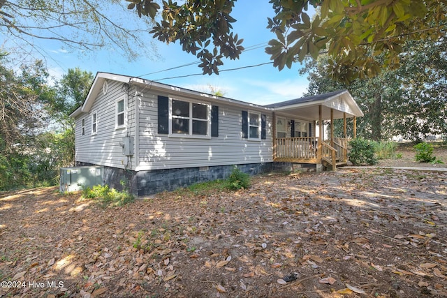 view of front of home featuring covered porch and central AC unit