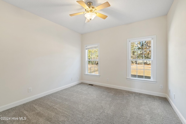 unfurnished room with carpet floors and ceiling fan