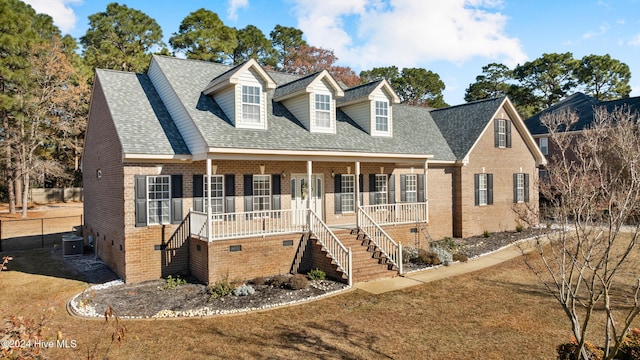 new england style home featuring a porch and central air condition unit