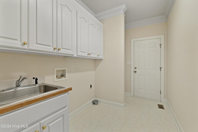 laundry room featuring sink, cabinets, washer hookup, hookup for an electric dryer, and crown molding