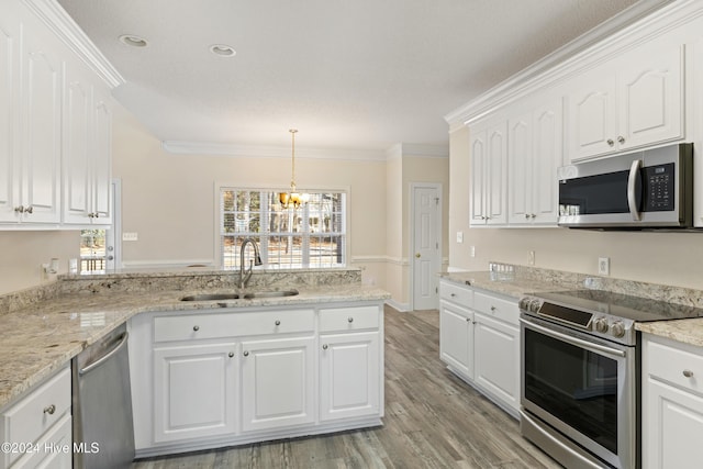 kitchen with stainless steel appliances, white cabinetry, ornamental molding, and light hardwood / wood-style flooring