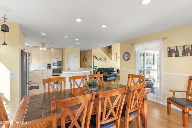 dining room featuring light wood-type flooring and ceiling fan