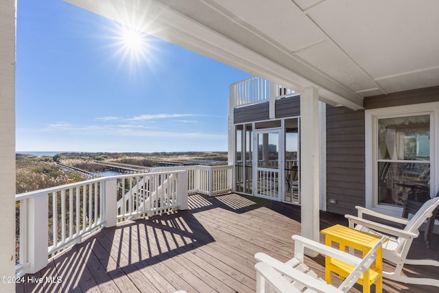 wooden deck with a water view