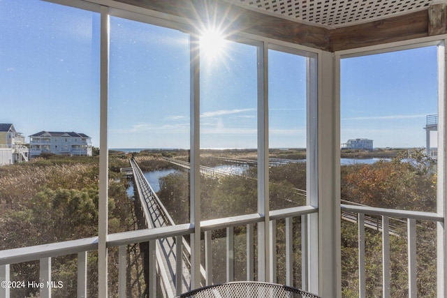 unfurnished sunroom with a water view