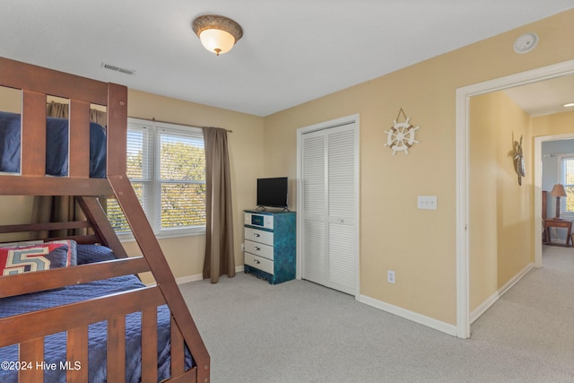 carpeted bedroom featuring a closet