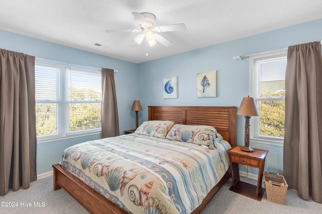 bedroom featuring light carpet and ceiling fan