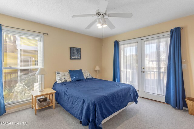 bedroom featuring light carpet, french doors, access to outside, and ceiling fan