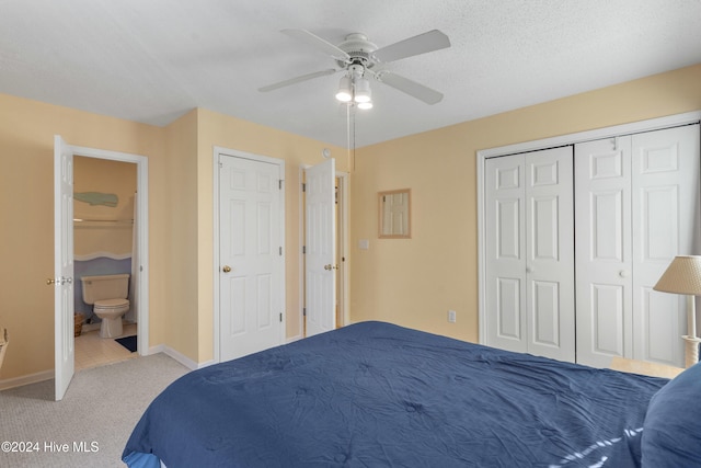 carpeted bedroom featuring ceiling fan, a textured ceiling, and connected bathroom