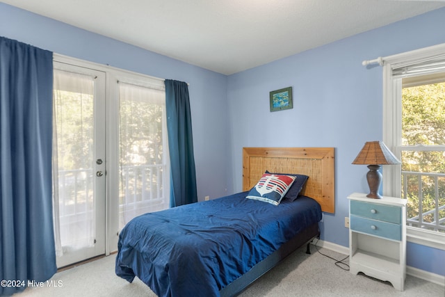 carpeted bedroom featuring french doors and access to outside