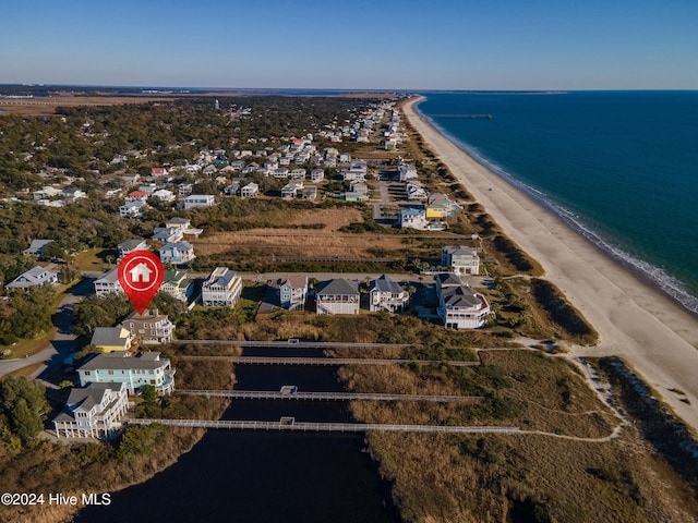 birds eye view of property featuring a water view and a beach view