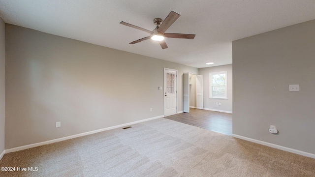 empty room featuring carpet flooring and ceiling fan