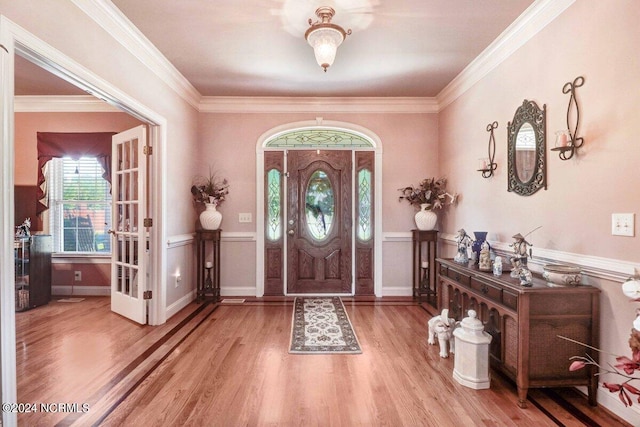 entryway featuring hardwood / wood-style flooring and crown molding