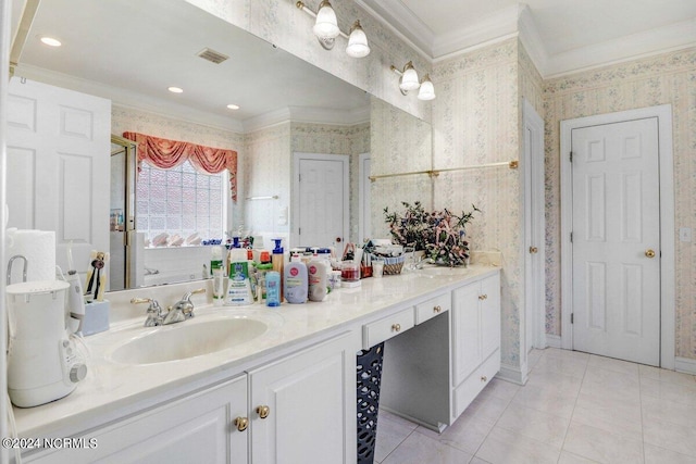 bathroom featuring tile patterned flooring, vanity, and crown molding