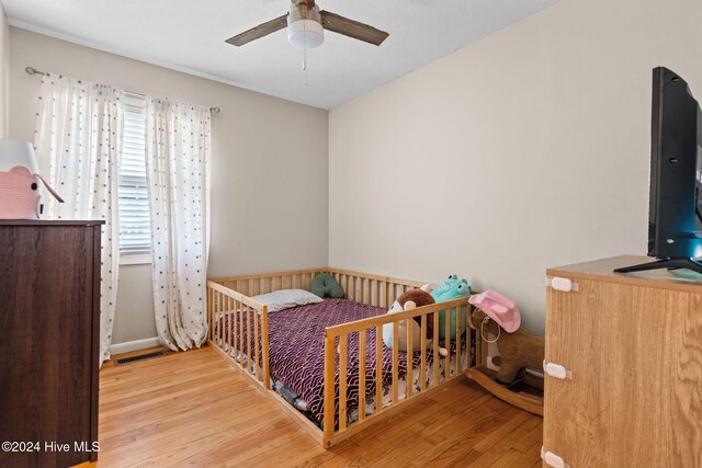 bedroom with hardwood / wood-style floors and ceiling fan