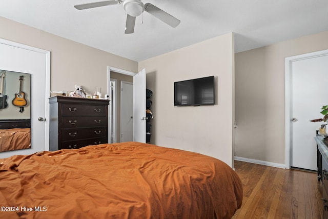 bedroom with ceiling fan and dark hardwood / wood-style flooring